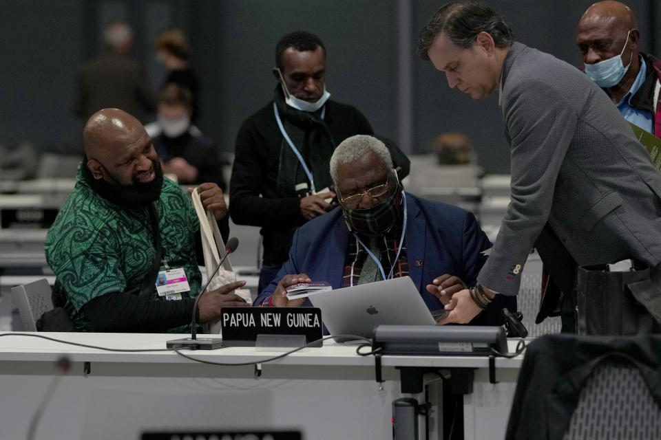 Papua New Guinea's Wera Mori, center, the Minister for Environment, Conservation & Climate Change attends a stocktaking plenary session at the COP26 U.N. Climate Summit, in Glasgow, Scotland, Saturday, Nov. 13, 2021. Going into overtime, negotiators at U.N. climate talks in Glasgow are still trying to find common ground on phasing out coal, when nations need to update their emission-cutting pledges and, especially, on money. (AP Photo/Alastair Grant)