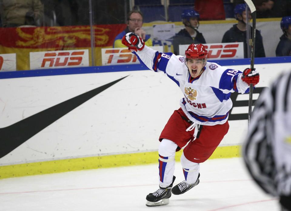 Russia's Pavel Buchnevich jubilates after scoring 3-5 into an empty goal after USA took out their goalie in the final minute of the World Junior Hockey Championships quarter final between USA and Russia in Malmo, Sweden on Thursday, Jan. 2, 2014. (AP Photo / TT News Agency / Andreas Hillergren) ** SWEDEN OUT **