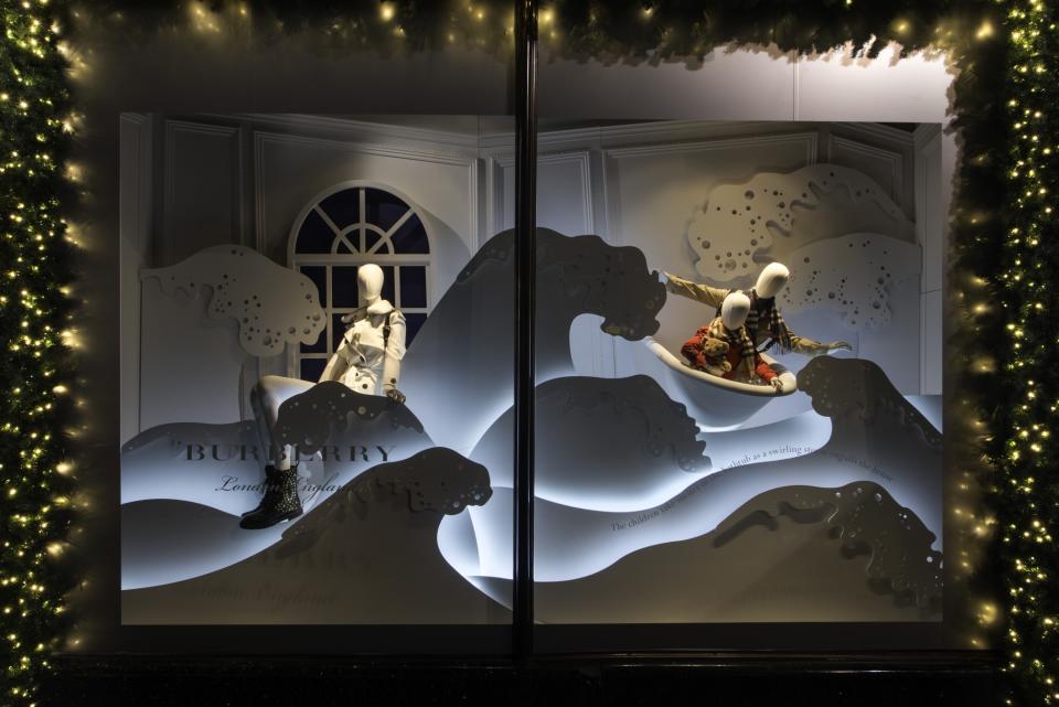 <p>It’s also the more minimal of window displays as the mannequins sled across white ‘snow’ panels [Photo: Harrods] </p>