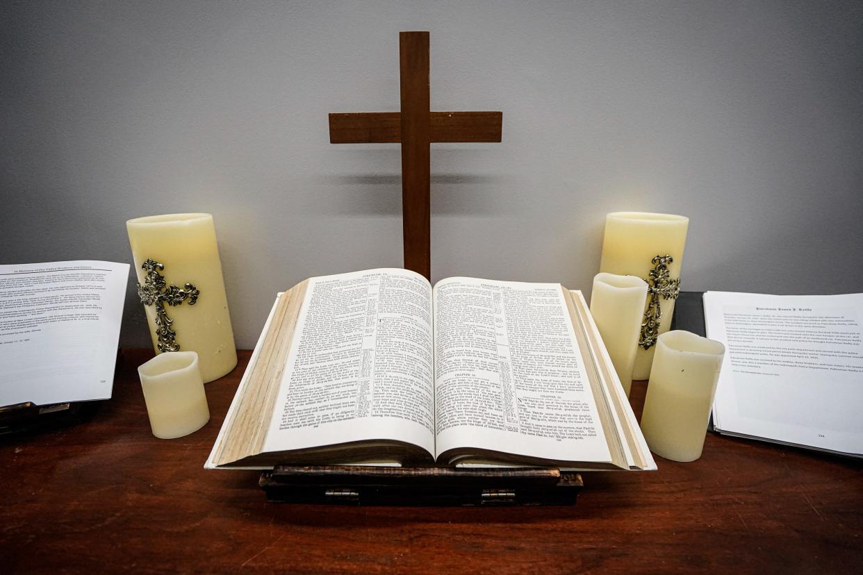 A bible and candles sit in the Indianapolis Metropolitan Police Department Senior Staff Chaplain office at the City County Building on October 21, 2022, in Indianapolis. It accompanies a book with every member of the department killed in the line of duty and other precious information. 