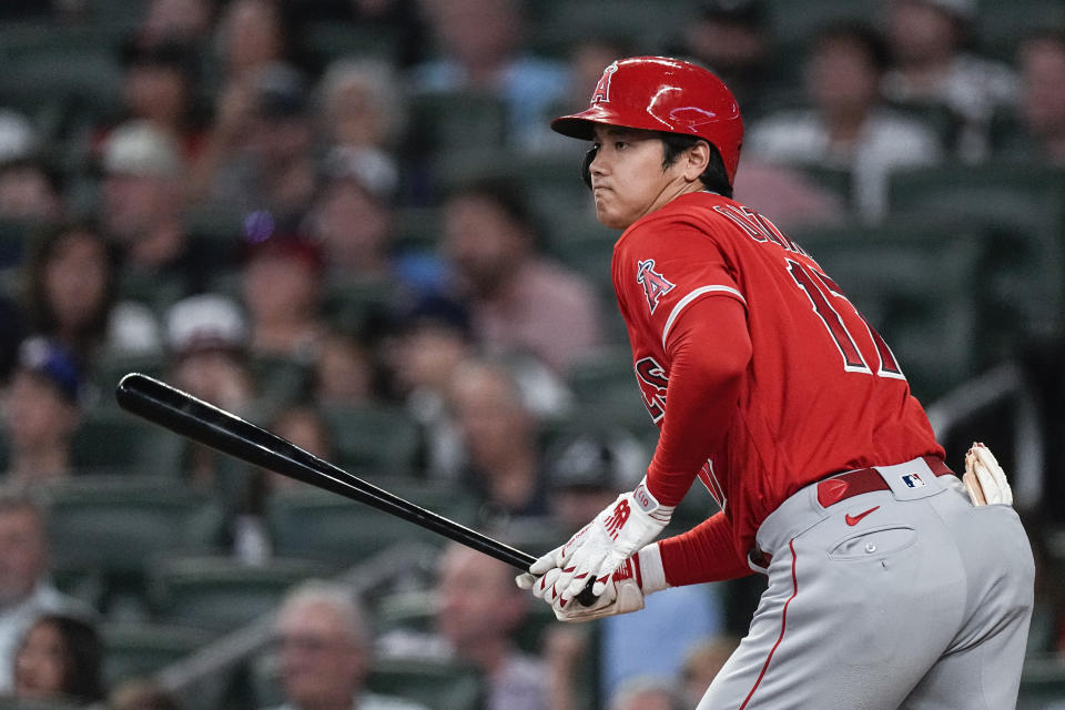 Los Angeles Angels' Shohei Ohtani hits a single in the sixth inning of a baseball game against the Atlanta Braves Tuesday, Aug. 1, 2023, in Atlanta. (AP Photo/John Bazemore)