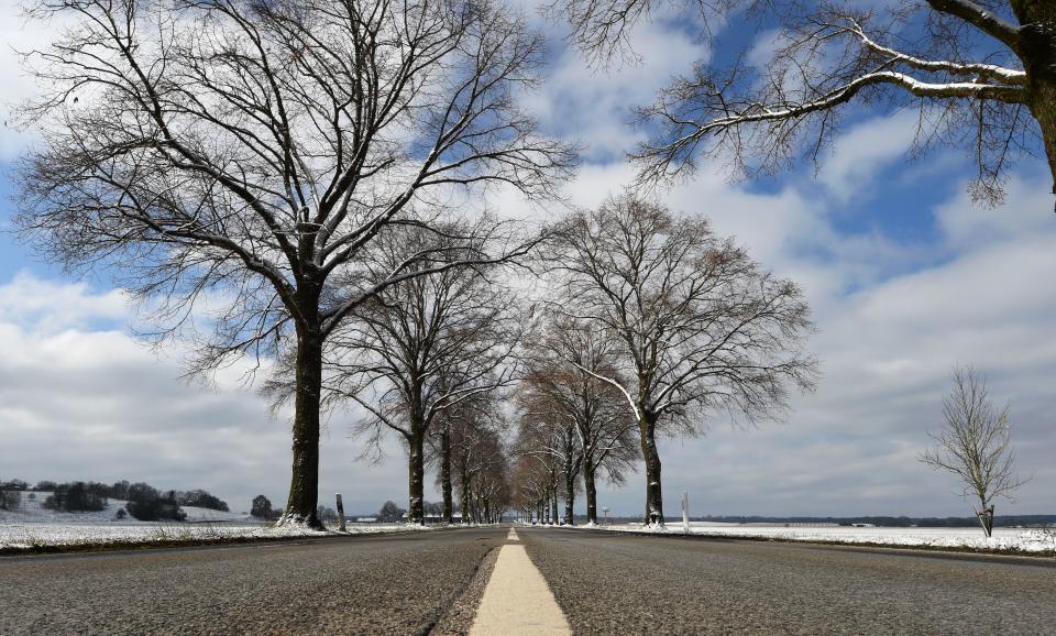 A street is pictured near the small Bavarian village of Alling, southern Germany, after snow fall on March 22, 2020 as more restrictions on daily life have come into force to combat the coronavirus Covid-19 pandemic. (Photo by Christof STACHE / AFP) (Photo by CHRISTOF STACHE/AFP via Getty Images)
