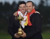 Team Europe golfers Rory McIlroy (L) and Sergio Garcia pose for a photograph with the Ryder Cup after the closing ceremony of the 40th Ryder Cup at Gleneagles in Scotland September 28, 2014. REUTERS/Toby Melville