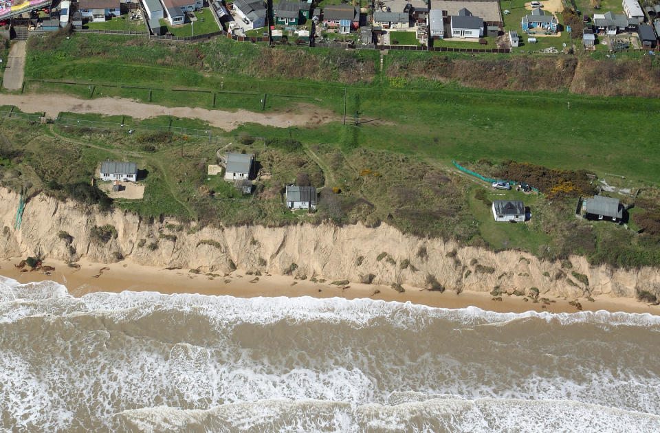 FILE PHOTO - The Hemsby shoreline in May 2018. See SWNS story SWBNhemsby. Terrified residents have been evacuated from their cliff edge homes amid fears their homes could plunge into the sea during last night's storm surge. At least five people fled their homes last night in Hemsby, Norfolk, as a high tide took chunks out of the sea bank their houses sit on.  According to coastguards a new 10ft drop has formed from the high tide last night, meaning the lifeboat can no longer be safely launched out to sea. Paving slabs from residents' back gardens have fallen into the sea as several residents moved all their belongings out of their homes in the dead of night yesterday (Mar 9).