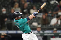 Seattle Mariners' Mitch Haniger hits a two-run home run against the Cleveland Indians during the seventh inning of a baseball game Friday, May 14, 2021, in Seattle. (AP Photo/Elaine Thompson)