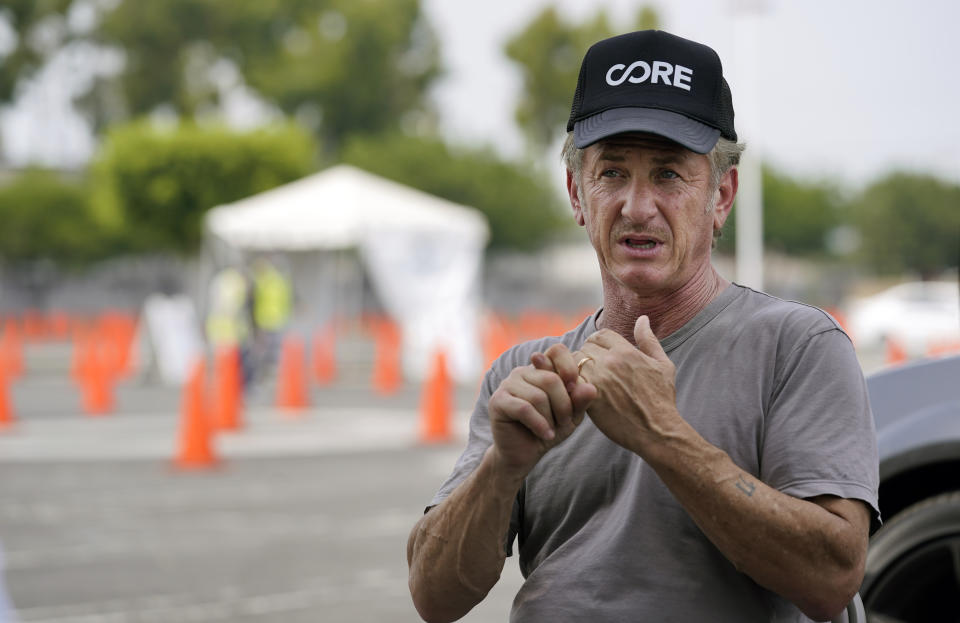 Actor Sean Penn, founder of Community Organized Relief Effort (CORE), is interviewed at a CORE coronavirus testing site at Crenshaw Christian Center, Friday, Aug. 21, 2020, in Los Angeles. Penn says his organization CORE has made some strides against the coronavirus and he's keeping its mission going by expanding testing and other relief services. (AP Photo/Chris Pizzello)
