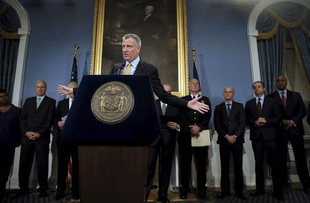 New York City Mayor Bill de Blasio speaks at a news conference as he is flanked by various local, state and dederal law enforcement officials at City Hall in the Manhattan borough of New York City, January 12, 2016. REUTERS/Mike Segar