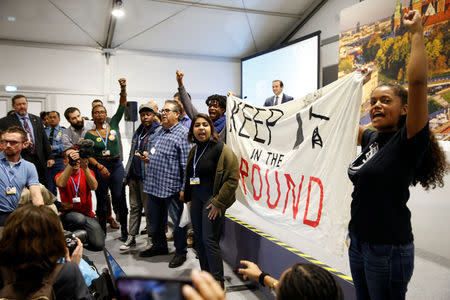 Environmental activists protest against fossil fuel during U.S. panel at the COP24 UN Climate Change Conference 2018 in Katowice, Poland, December 10, 2018