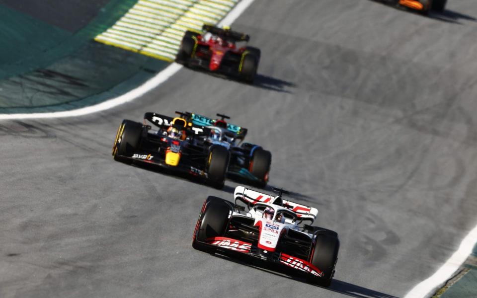 Kevin Magnussen of Denmark driving the (20) Haas F1 VF-22 Ferrari leads Max Verstappen of the Netherlands driving the (1) Oracle Red Bull Racing RB18 and George Russell of Great Britain driving the (63) Mercedes AMG Petronas F1 Team W13 on track during the Sprint ahead of the F1 Grand Prix of Brazil at Autodromo Jose Carlos Pace on November 12, 2022 in Sao Paulo, Brazil - Chris Graythen/Getty Images