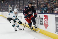 Columbus Blue Jackets' Max Domi, right, jumps the stick of San Jose Sharks' Erik Karlsson during the second period of an NHL hockey game Sunday, Dec. 5, 2021, in Columbus, Ohio. (AP Photo/Jay LaPrete)