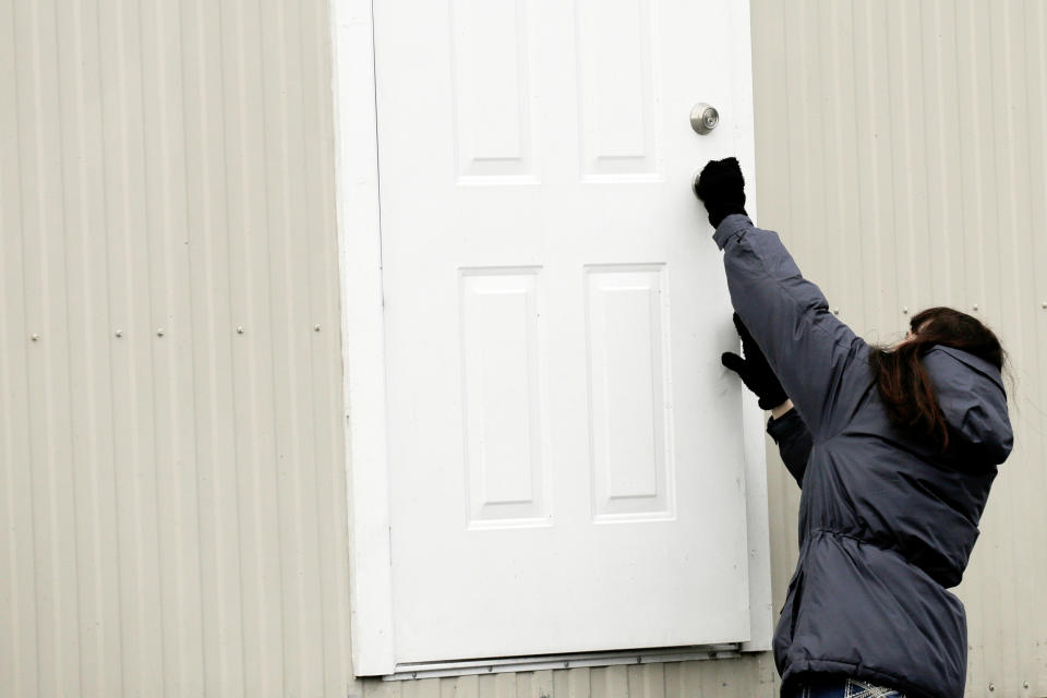King County property agent Tami Elmer closes the door to one of 18 modular units that King County is using to house patients for treatment and isolation in relation to coronavirus is seen in Seattle, Washington, U.S. March 3, 2020.  REUTERS/David Ryder