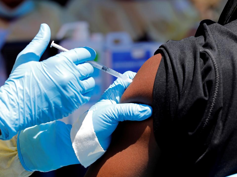 FILE PHOTO: A health worker injects a man with Ebola vaccine in Goma, Democratic Republic of Congo, August 5, 2019. REUTERS/Baz Ratner/File Photo