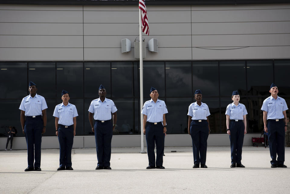 New graduates recite the Airman’s Creed at Basic Military Training during the Coin Ceremony at Joint Base San Antonio-Lackland, in San Antonio, April 26, 2023. The U.S. military has struggled to overcome recruiting shortfalls and as a way to address that problem, it's stepping up efforts to sign up immigrants, offering a fast track to American citizenship to those who join the armed services. The graduates were part of the first group of 14 who graduated from basic training and were sworn in as new citizens under the new initiative. (Vanessa R. Adame/U.S. Air Force via AP)