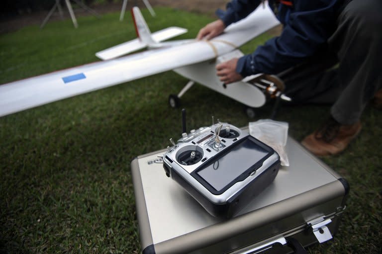 A man prepares a drone before its launch in Lima, Peru on July 10, 2013. In agriculture, high-quality images allow experts to measure the amount of sunlight the plants are getting, and study plant problems like stress from heat, drought or lack of nutrients,