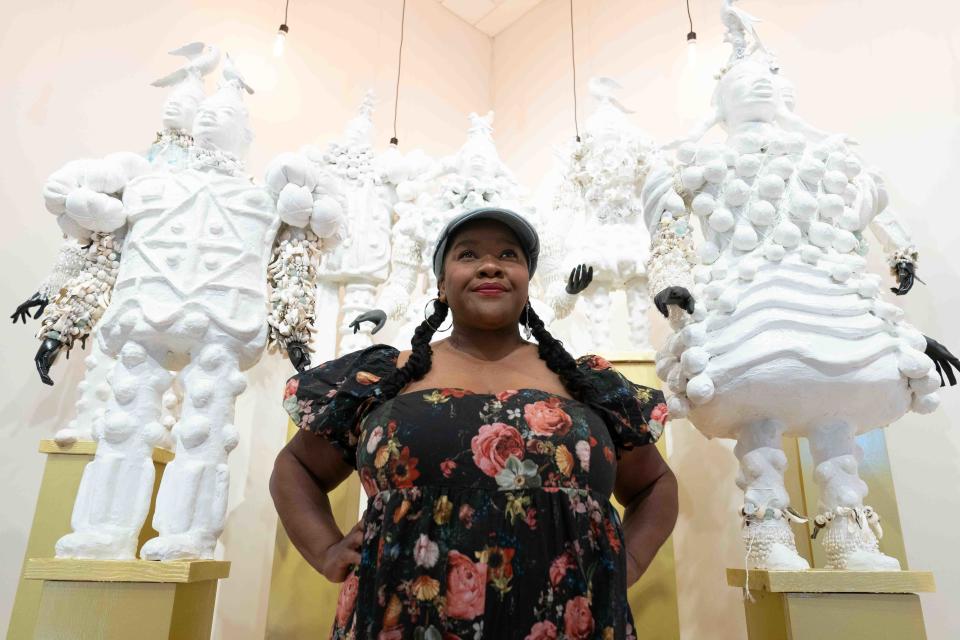Artist vanessa german stands in front of "ET AL," or "The Child Plaintiffs as Power-figures" Tuesday at the Rita Blitt Gallery at Mulvane Art Museum. The piece is part of german's latest exhibit "CRAVING LIGHT: The Museum of Love & Reckoning," which will open Thursday.