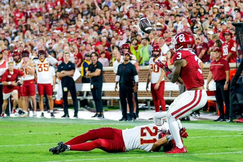 OU's Jalil Farooq (3) catches a pass over Iowa State's Jamison Patton (21) in the second quarter of a 50-20 win on Saturday at Owen Field in Norman.