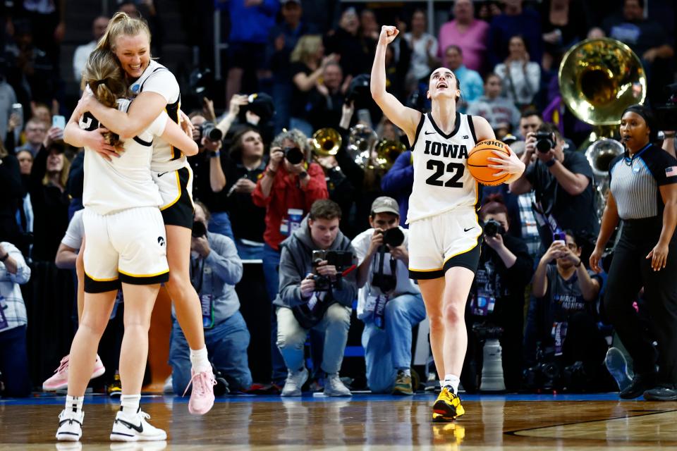 Iowa star guard Caitlin Clark (22), seen here celebrating an NCAA regional final win over LSU, deserves to be celebrated for how much she elevated women's college basketball, not dismissed on national television by all-time WNBA leading scorer Diana Taurasi.