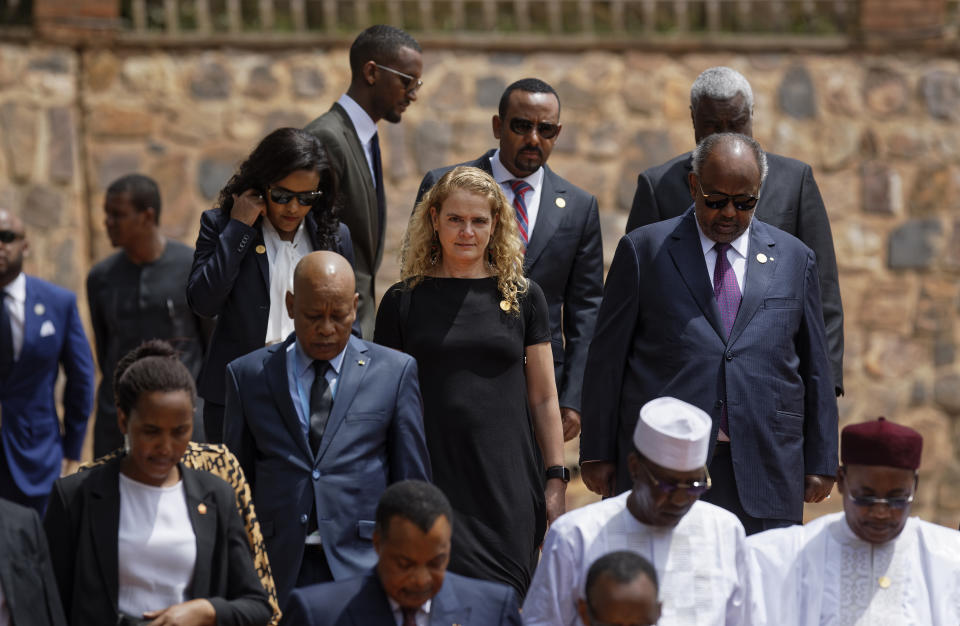Governor General of Canada Julie Payette, center, arrives to lay a wreath at the Kigali Genocide Memorial in Kigali, Rwanda Sunday, April 7, 2019. Rwanda is commemorating the 25th anniversary of when the country descended into an orgy of violence in which some 800,000 Tutsis and moderate Hutus were massacred by the majority Hutu population over a 100-day period in what was the worst genocide in recent history. (AP Photo/Ben Curtis)