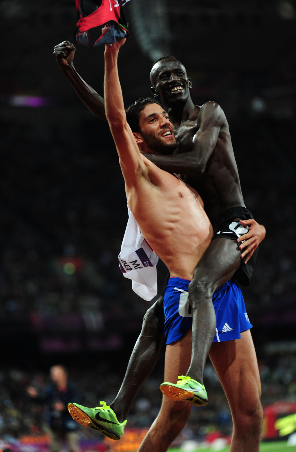 LONDON, ENGLAND - AUGUST 05: Silver medalist Mahiedine Mekhissi-Benabbad of France celebrates with gold medalist Ezekiel Kemboi of Kenya celebrate after the Men's 3000m Steeplechase on Day 9 of the London 2012 Olympic Games at the Olympic Stadium on August 5, 2012 in London, England. (Photo by Stu Forster/Getty Images)