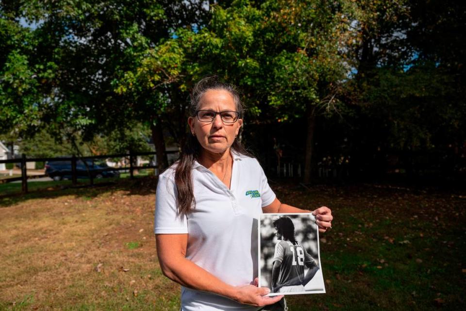 Ana Suarez Fleming poses for a portrait outside her home holding a photo of her brother, the late Carolina Lightnin’ soccer star Tony Suarez, on Friday, October 29, 2021 in Monroe, NC.