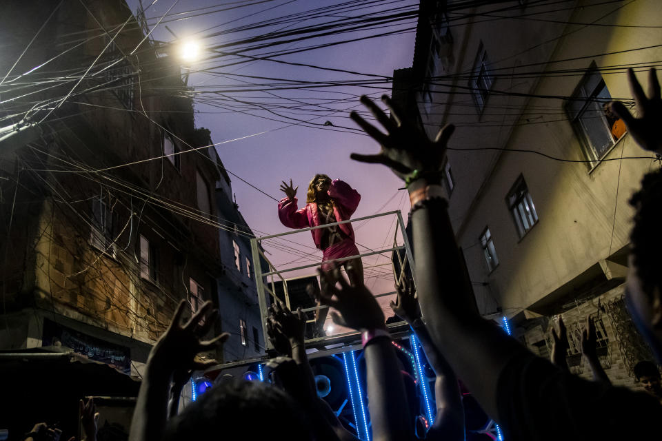 Artist Preta Queenb Rull performs during an LGBT+ artistic show entitled "Noite das Estrelas" or the Night of the Stars, at the Mare Favela complex, in Rio de Janeiro, Brazil, Sunday, June 25, 2023. The show which honors the LGBT+ movements of the 1980s and 1990s, travels through the streets and occupies cultural facilities in the community. (AP Photo/Bruna Prado)