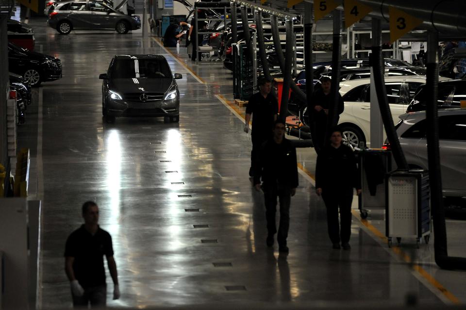Workers and assembled cars are seen in the assembly hall in the new Mercedes plant in Kecskemet, 83 kilometers southeast of Budapest, Hungary, prior to the the official inauguration ceremony of the Kecskemet Mercedes factory on Thursday, 29 March, 2012. The new Mercedes plant built on a basic territory of 441 hectares with an investment of 800 million euros has a yearly capacity of 100 thousand cars of two types of compact B-Class produced by 2,500 employees. (AP Photo/MTI, Tamas Kovacs)