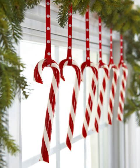 <p>Keep treats on display (and out of kids' and pets' reach) by hanging them along the top of a window. Hooked on matching ribbon, the peppermints look extra sweet. </p><p>See more at <a href="http://www.goodhousekeeping.com/holidays/christmas-ideas/how-to/g2203/christmas-decoration-ideas/" rel="nofollow noopener" target="_blank" data-ylk="slk:Good Housekeeping;elm:context_link;itc:0;sec:content-canvas" class="link ">Good Housekeeping</a>. </p>