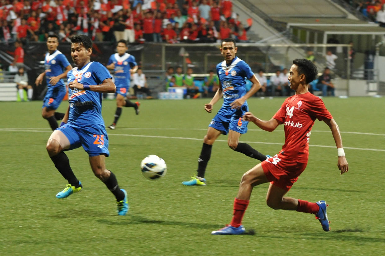 Singapore's LionsXll player Faris Ramli (right) in action against KL Felda United in their the Malaysian Super League clash in 2013.