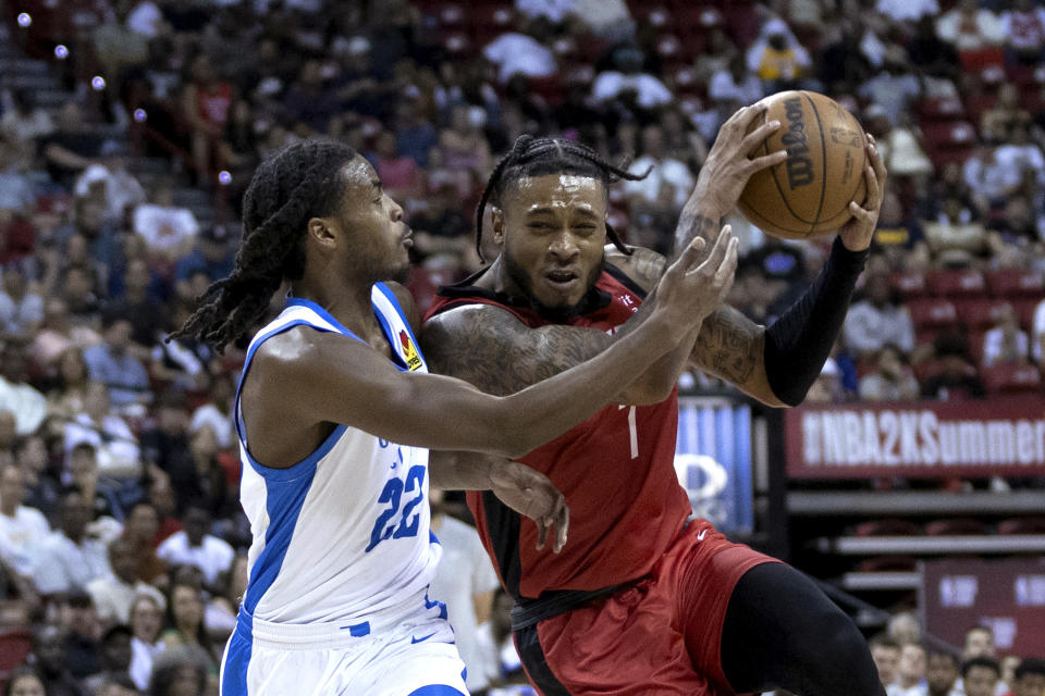 Houston Rockets forward Cam Whitmore (7) drives around Oklahoma City Thunder guard Cason Wallace (22) during an NBA summer league basketball game Tuesday, July 11, 2023, in Las Vegas. (Ellen Schmidt/Las Vegas Review-Journal via AP)