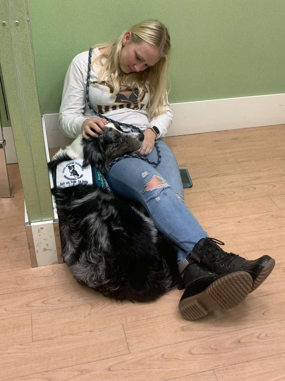 Carissa Tank, owner of Scar's AUSSome Training, takes her service dog Scar into public spaces like stores where his support is necessary. He is trained in mobility tasks and preventing and alerting panic attacks.