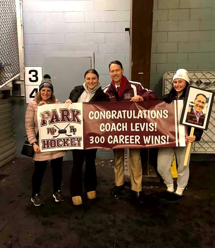 Park ice hockey coach Tom Levis celebrates his 300th career victory with wife Karen and daughters Julia and Samantha, on Dec. 28, 2022.