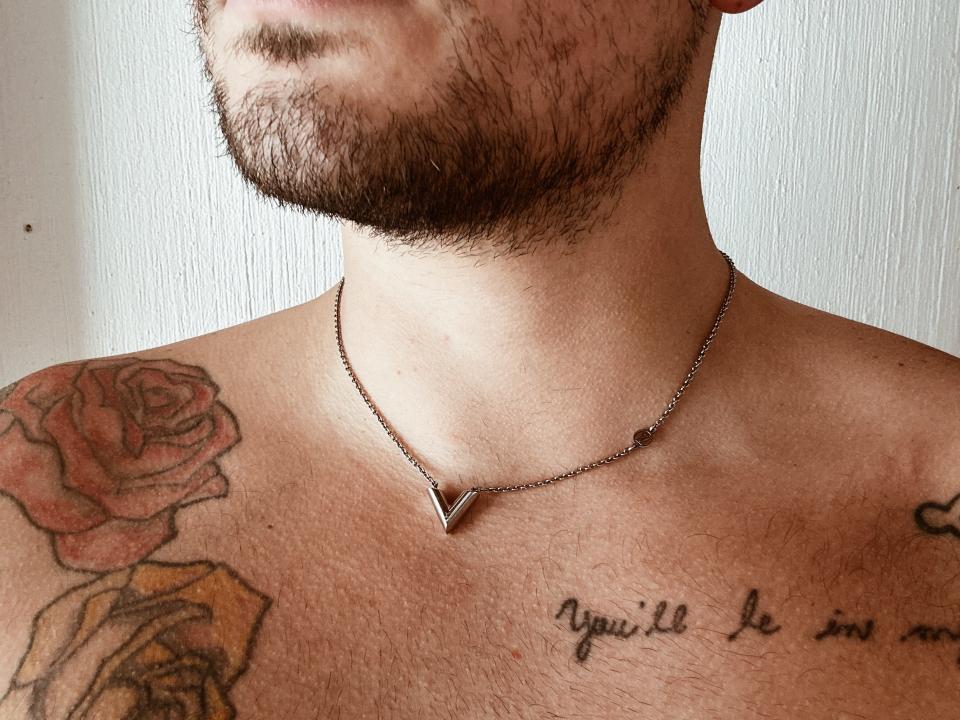 Louis Vuitton V necklace on christian's neck