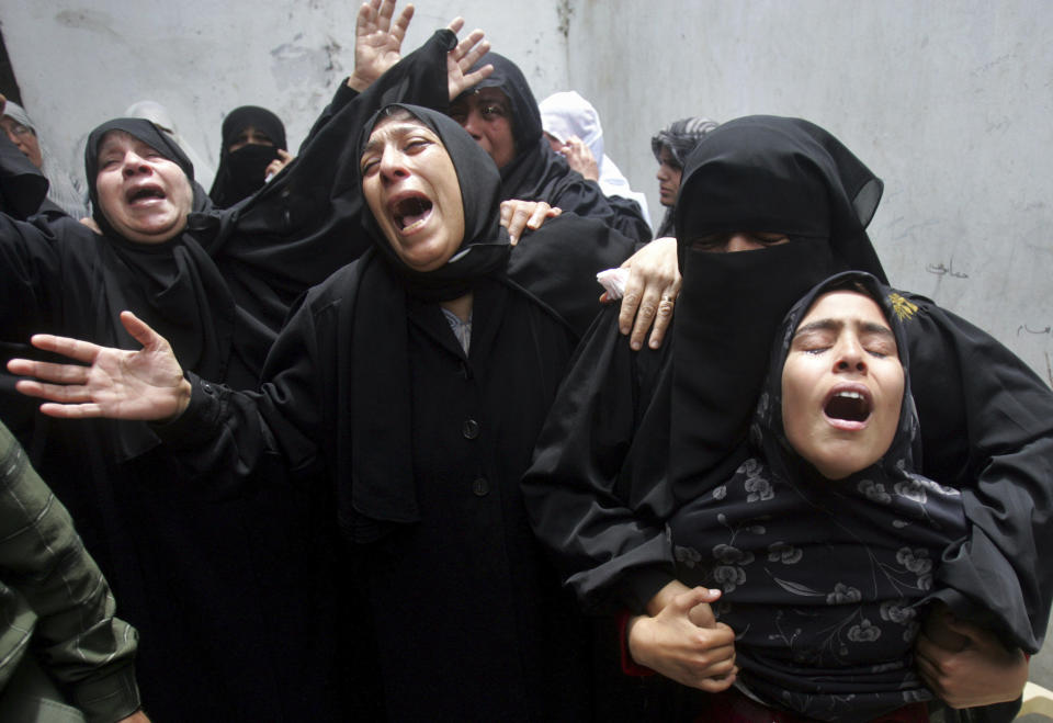 FILE - Palestinian relatives of Hamas militant Abdul Halem al-Fayomi, react at the family house during his funeral in Gaza City, Saturday, April 28, 2007. Israeli troops on Saturday killed at least three Hamas militants who were en route to carrying out an attack, throwing a shaky truce along the Gaza-Israel border further into question. (AP Photo/Khalil Hamra, File)