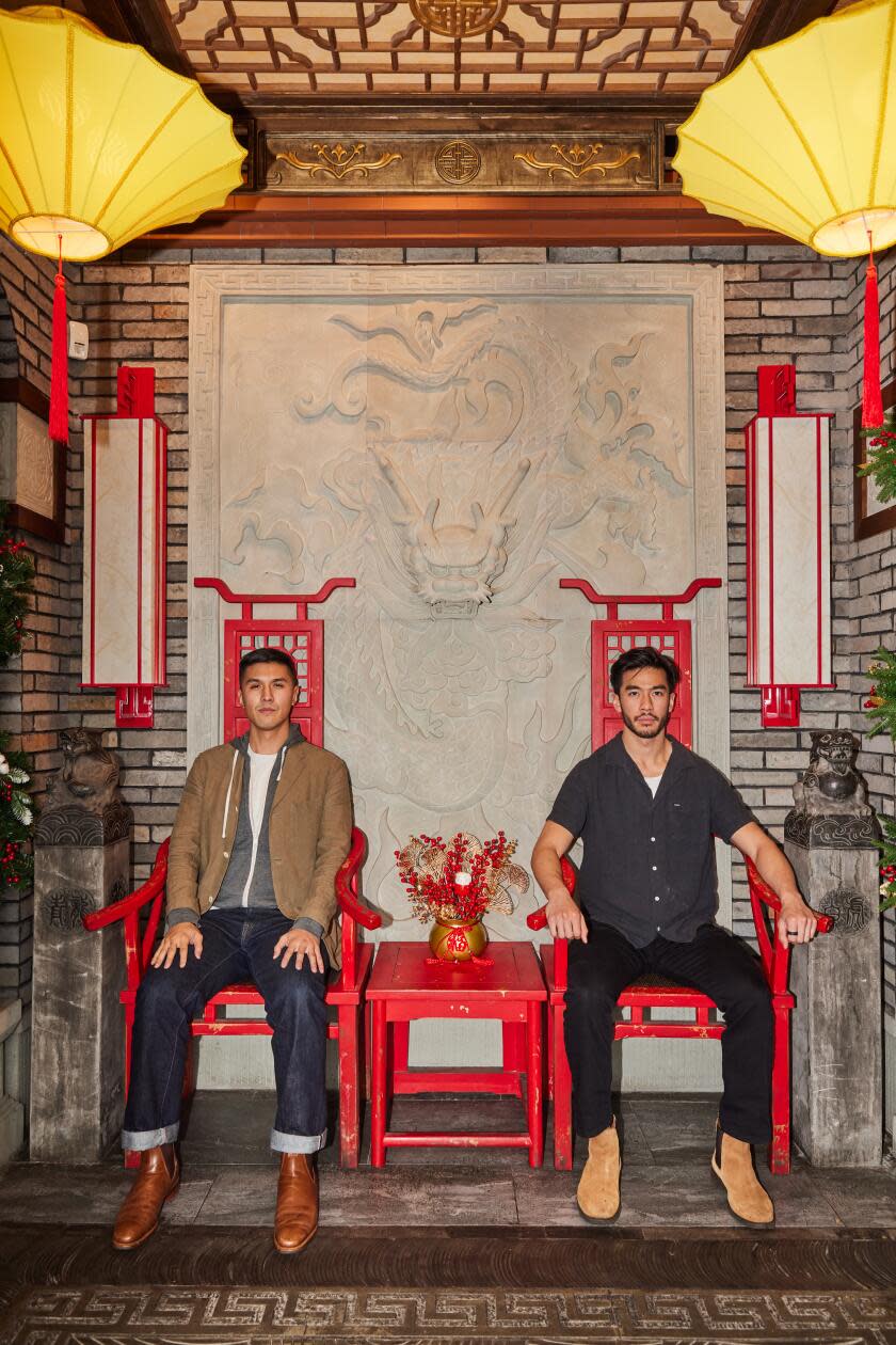 Two men sitting in red lacquered chairs