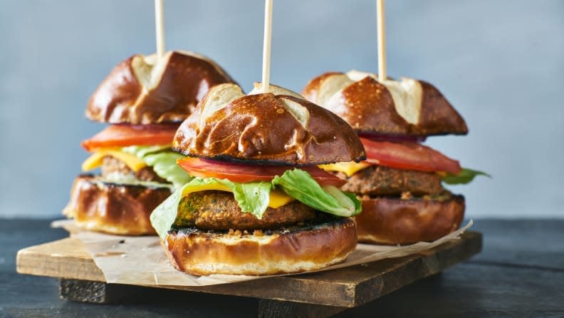 Three vegan burger sliders with pretzel buns