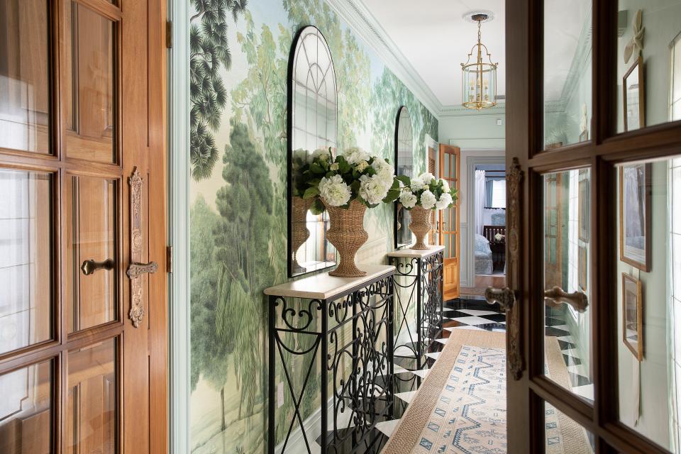 Designer Elizabeth Ghia installed Iksel’s Italian Panoramic mural wallpaper and custom wrought iron consoles in the graceful entry of a 1926 home in Coral Gables’ Italian Village.
