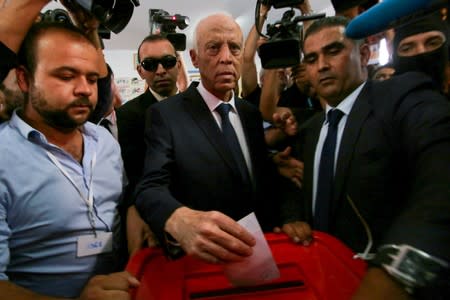 Tunisian presidential candidate Kais Saied casts his vote at a polling station