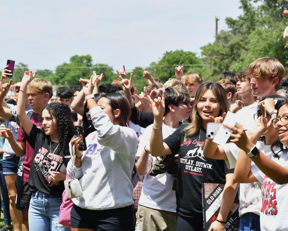 Wichita Falls High School students show their school spirit during the alma mater at the school closing ceremony on Wednesday.