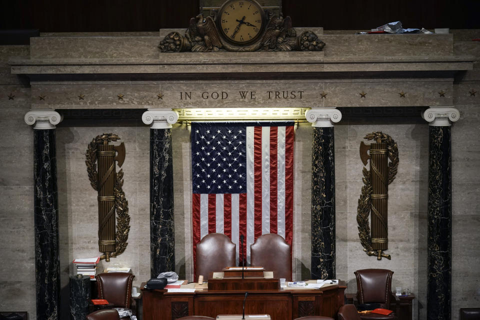 FILE - In this Jan. 6, 2021 file photo, the House Chamber is empty after a hasty evacuation as rioters tried to break into the chamber at the U.S. Capitol in Washington. President Joe Biden’s first address to Congress is an invite-only affair, and no guests allowed. The restrictions for Wednesday’s event are due to COVID-19 safety protocols, but will have the added security benefit of a limited number of people inside the Capitol for the president’s first major indoor event since he took office just weeks after the Jan. 6 insurrection. The fence is still up around the U.S. Capitol, and the National Guard is still there. (AP Photo/J. Scott Applewhite)