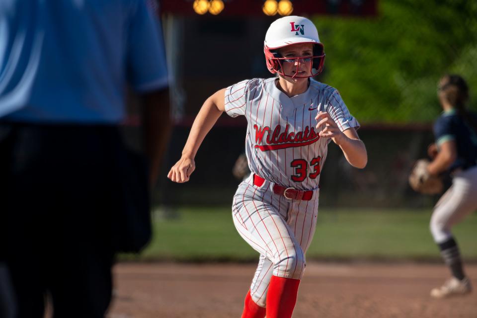 Lawrence North High School junior Ella Hogan (33) runs to home plate to score during a IHSAA Class 4A Softball Sectional Championship game against Indianapolis Cathedral High School, Friday, May 26, 2023, at North Central High School.