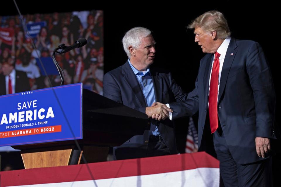 Former President Donald Trump welcomes candidate for US Senate Rep Mo Brooks to the stage during a 