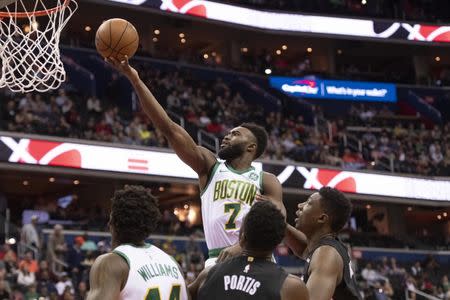 Apr 9, 2019; Washington, DC, USA; Boston Celtics guard Jaylen Brown (7) shoots as Washington Wizards forward Troy Brown Jr. (6) and center Thomas Bryant (13) defend during the first quarter at Capital One Arena. Mandatory Credit: Tommy Gilligan-USA TODAY Sports