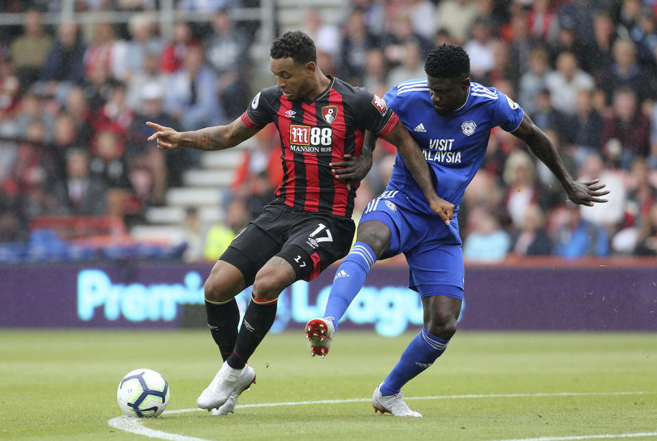Bournemouth's Joshua King, left, and Cardiff City's Bruno Ecuele Manga in action during their English Premier League soccer match at the Vitality Stadium in Bournemouth, England, Saturday Aug. 11, 2018. (Mark Kerton/PA via AP)