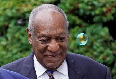 A soap bubble blown by a protester drifts past actor and comedian Bill Cosby as he arrives at the Montgomery County Courthouse for sentencing in his sexual assault trial in Norristown, Pennsylvania, U.S., September 24, 2018. REUTERS/Jessica Kourkounis