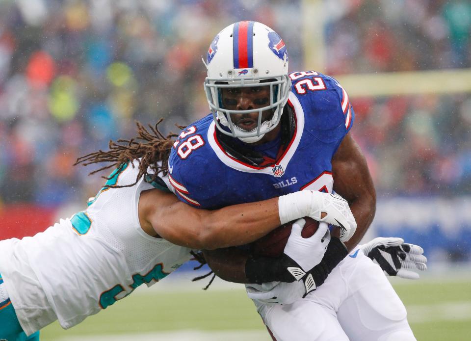 Buffalo Bills running back C.J. Spiller (28) is hit by Miami Dolphins outside linebacker Philip Wheeler (52) during the first half of an NFL football game on Sunday, Dec. 22, 2013, in Orchard Park, N.Y.