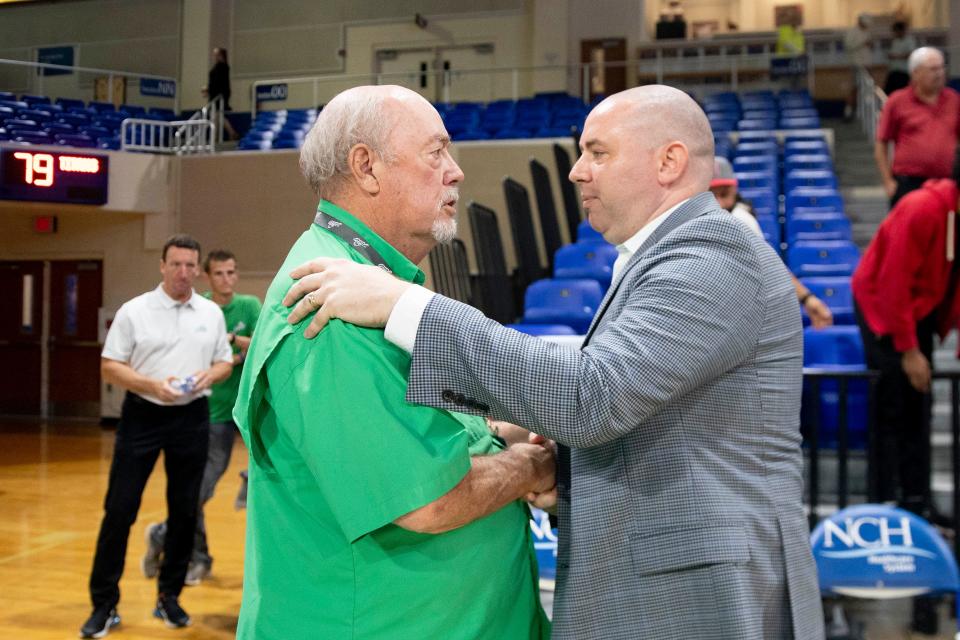 Florida Gulf Coast Eagles head coach Michael Fly and, Dr. Michael Martin, the president of FGCU, shake hands after defeating the Detroit Mercy Titans 95-79 in the first round of The Basketball Classic presented by Eracism, Wednesday, March 16, 2022, at Alico Arena in Fort Myers, Fla.