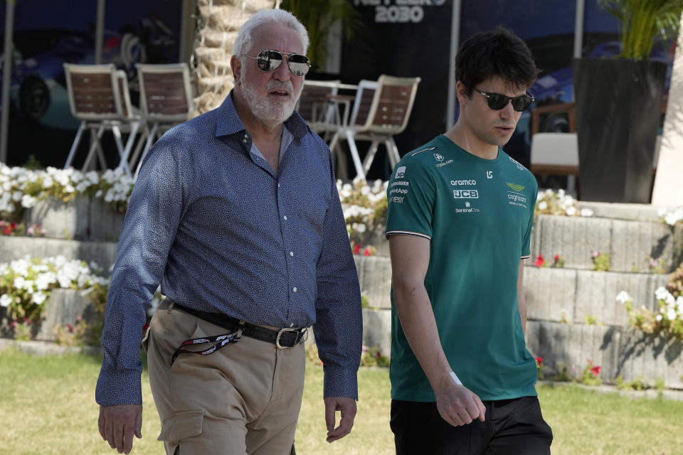 Aston Martin driver Lance Stroll of Canada , right, and his father Lawrence arrive at the Bahrain International Circuit in Sakhir, Bahrain, Thursday, March 2, 2023. The Bahrain GP will be held on Sunday March 5, 2023.(AP Photo/Frank Augstein)