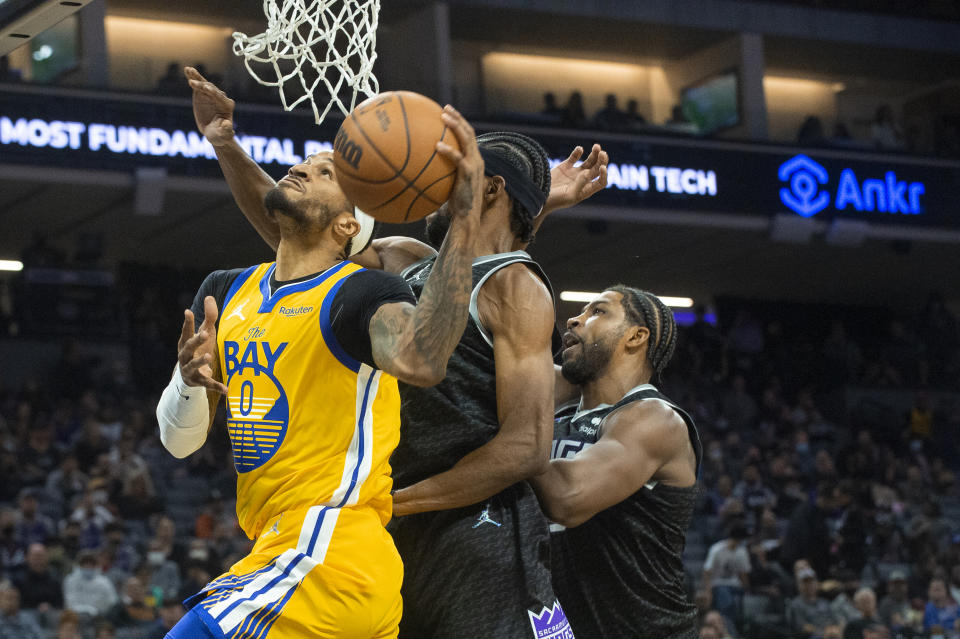 Golden State Warriors guard Gary Payton II (0) drives to the basket against the Sacramento Kings during the first quarter of an NBA basketball game in Sacramento, Calif., Sunday, Oct. 24, 2021. (AP Photo/Randall Benton)