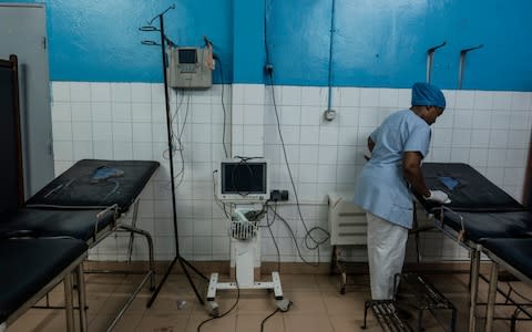 A nurse cleans a couch at the Maternity Ward at the Hospital Hombo, the main referral hospital at Mutsamudu, capital of the island of Anjouan, on November 17, 2018  - Credit: Eduardo Soteras Jalil /The Telegraph