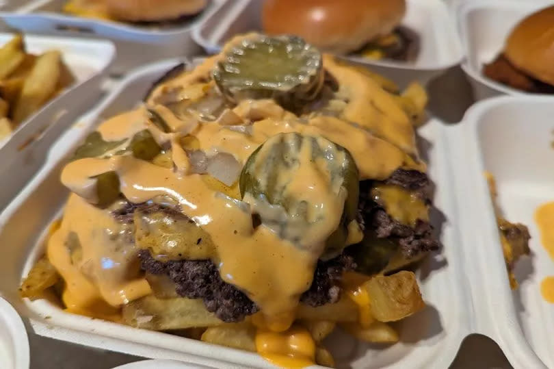 Smashburger Fries, topped with diced smashburger, American cheese, pickles, onions and burger sauce